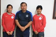 Indian Women's Team Coach Anadi Barua (centre) with players Romi Devi (left) and Tuli Goon (right).